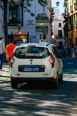 Seville Spain September 18, 2021 Taxi driving through the streets of Seville during the coronavirus outbreak hitting Spain, wearing a mask is mandatoryのeditorial素材
