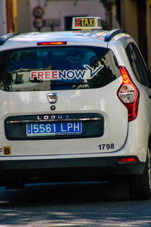 Seville Spain September 18, 2021 Taxi driving through the streets of Seville during the coronavirus outbreak hitting Spain, wearing a mask is mandatoryのeditorial素材
