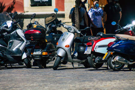Seville Spain September 18, 2021 Motorcycles parked in the streets of Seville, an emblematic city and the capital of the region of Andalusia, in the south of Spainのeditorial素材