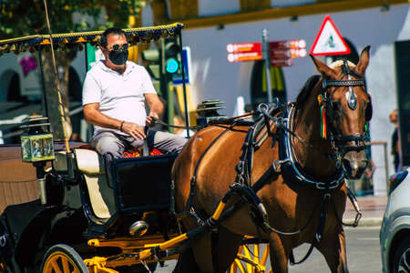 Seville Spain September 18, 2021 Horse drawn carriage ride through the streets of Seville during the coronavirus outbreak hitting Spain, wearing a mask is mandatoryのeditorial素材
