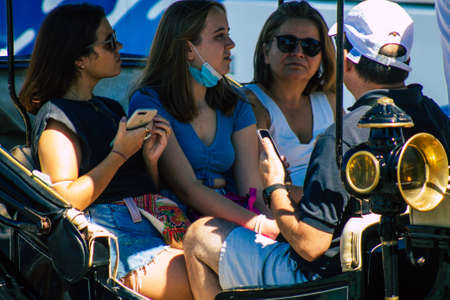 Seville Spain September 18, 2021 Horse drawn carriage ride through the streets of Seville during the coronavirus outbreak hitting Spain, wearing a mask is mandatoryのeditorial素材