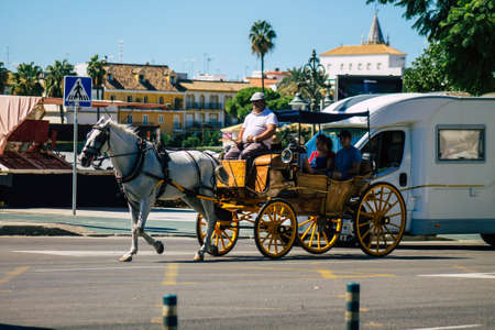 Seville Spain September 18, 2021 Horse drawn carriage ride through the streets of Seville during the coronavirus outbreak hitting Spain, wearing a mask is mandatoryのeditorial素材
