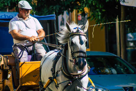 Seville Spain September 18, 2021 Horse drawn carriage ride through the streets of Seville during the coronavirus outbreak hitting Spain, wearing a mask is mandatoryのeditorial素材