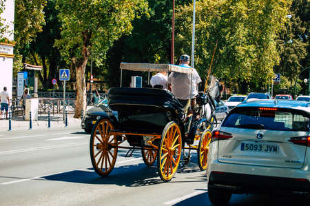 Seville Spain September 18, 2021 Horse drawn carriage ride through the streets of Seville during the coronavirus outbreak hitting Spain, wearing a mask is mandatoryのeditorial素材