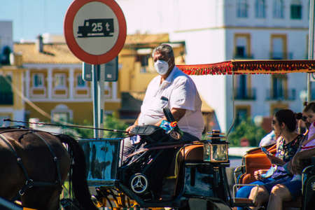 Seville Spain September 18, 2021 Horse drawn carriage ride through the streets of Seville during the coronavirus outbreak hitting Spain, wearing a mask is mandatoryのeditorial素材