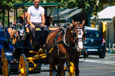 Seville Spain September 18, 2021 Horse drawn carriage ride through the streets of Seville during the coronavirus outbreak hitting Spain, wearing a mask is mandatoryのeditorial素材