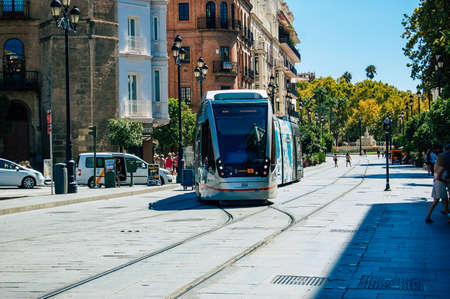 Seville Spain September 18, 2021 Modern electric tram for passengers rolling through the streets of Seville during the coronavirus outbreak hitting Spain, wearing a mask is mandatoryのeditorial素材