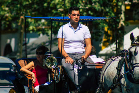 Seville Spain September 18, 2021 Horse drawn carriage ride through the streets of Seville during the coronavirus outbreak hitting Spain, wearing a mask is mandatoryのeditorial素材