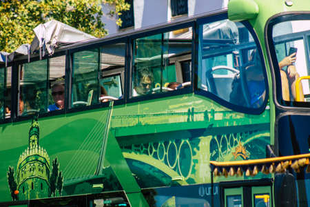 Seville Spain September 18, 2021 Tourist bus driving through the streets of Seville during the coronavirus outbreak hitting Spain, wearing a mask is mandatoryのeditorial素材