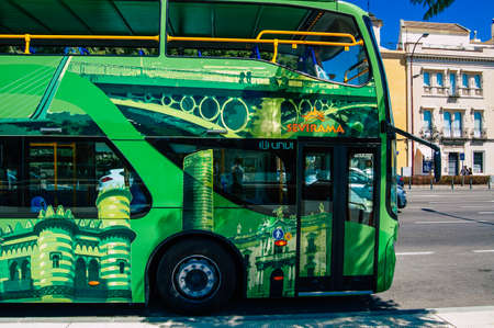 Seville Spain September 18, 2021 Tourist bus driving through the streets of Seville during the coronavirus outbreak hitting Spain, wearing a mask is mandatoryのeditorial素材