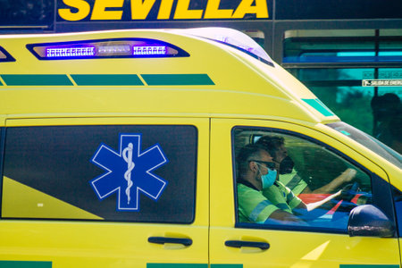 Seville Spain September 18, 2021 Ambulance driving through the streets of Seville during the coronavirus outbreak hitting Spain, wearing a mask is mandatoryのeditorial素材