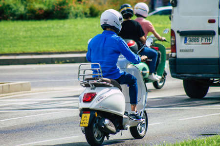 Seville Spain September 15, 2021 People rolling with a scooter in the streets of Seville, an emblematic city and the capital of the region of Andalusia, in the south of Spainのeditorial素材