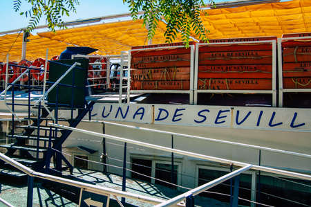 Seville Spain September 18, 2021 Tourist boats on the Guadalquivir River that crosses Seville, an emblematic city and the capital of the region of Andalusia, in the south of Spainのeditorial素材