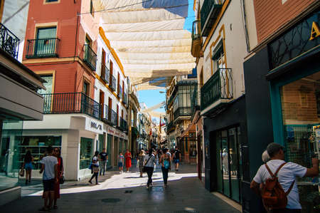 Seville Spain September 18, 2021 Pedestrians walking in the street during the coronavirus outbreak hitting Spain, wearing a mask is not mandatory but most of people wear itのeditorial素材
