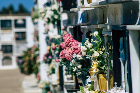 Seville Spain September 21, 2021 Typical graves in a Christian cemetery of the municipality of Carmona in Andalusia in southern Spain, the graves are made in the depth of a wall and richly decoratedのeditorial素材