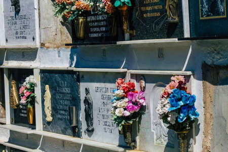 Seville Spain September 21, 2021 Typical graves in a Christian cemetery of the municipality of Carmona in Andalusia in southern Spain, the graves are made in the depth of a wall and richly decoratedのeditorial素材