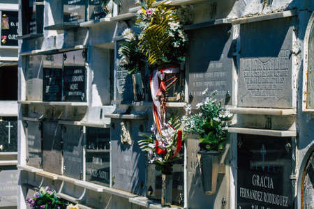 Seville Spain September 21, 2021 Typical graves in a Christian cemetery of the municipality of Carmona in Andalusia in southern Spain, the graves are made in the depth of a wall and richly decoratedのeditorial素材