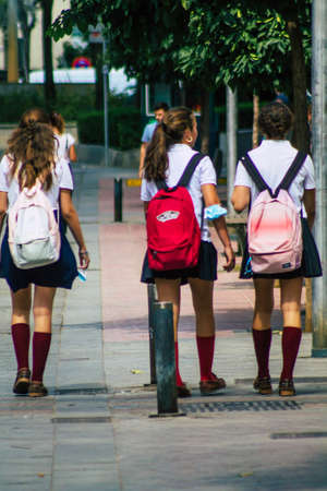 Seville Spain September 22, 2021 School girl walking in the street during the coronavirus outbreak hitting Spain, wearing a mask is not mandatory but most people wear itのeditorial素材