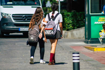 Seville Spain September 22, 2021 School girl walking in the street during the coronavirus outbreak hitting Spain, wearing a mask is not mandatory but most people wear itのeditorial素材