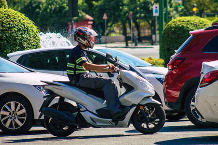 Seville Spain September 22, 2021 People rolling with a motorcycle in the streets of Seville, an emblematic city and the capital of the region of Andalusia, in the south of Spainのeditorial素材