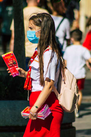 Seville Spain September 22, 2021 Young woman working like a guide tour with tourists in the street during the coronavirus outbreak hitting Spainのeditorial素材