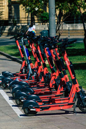 Seville Spain September 22, 2021 Electric scooter to rent parked in the streets of Seville, operating with a small utility internal combustion engines and a deck in the centerのeditorial素材
