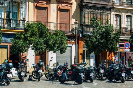 Seville Spain September 18, 2021 Motorcycles parked in the streets of Seville, an emblematic city and the capital of the region of Andalusia, in the south of Spainのeditorial素材