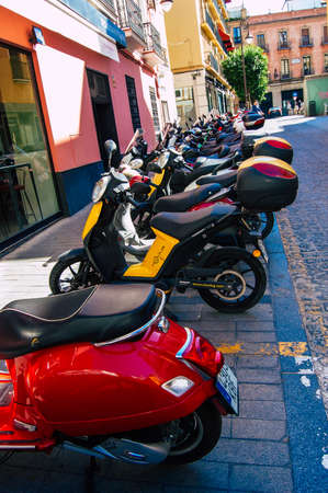 Seville Spain September 18, 2021 Motorcycles parked in the streets of Seville, an emblematic city and the capital of the region of Andalusia, in the south of Spainのeditorial素材