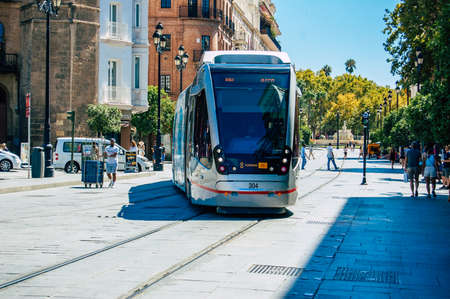 Seville Spain September 18, 2021 Modern electric tram for passengers rolling through the streets of Seville during the coronavirus outbreak hitting Spain, wearing a mask is mandatoryのeditorial素材