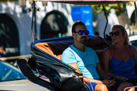 Seville Spain September 18, 2021 Horse drawn carriage ride through the streets of Seville during the coronavirus outbreak hitting Spain, wearing a mask is mandatoryのeditorial素材