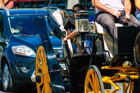 Seville Spain September 18, 2021 Horse drawn carriage ride through the streets of Seville during the coronavirus outbreak hitting Spain, wearing a mask is mandatoryのeditorial素材