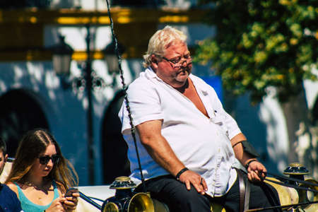 Seville Spain September 18, 2021 Horse drawn carriage ride through the streets of Seville during the coronavirus outbreak hitting Spain, wearing a mask is mandatoryのeditorial素材