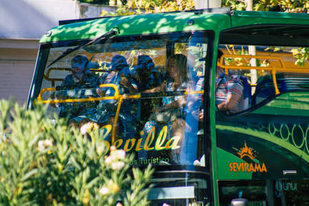 Seville Spain September 18, 2021 Tourist bus driving through the streets of Seville during the coronavirus outbreak hitting Spain, wearing a mask is mandatoryのeditorial素材