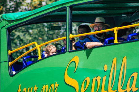 Seville Spain September 18, 2021 Tourist bus driving through the streets of Seville during the coronavirus outbreak hitting Spain, wearing a mask is mandatoryのeditorial素材