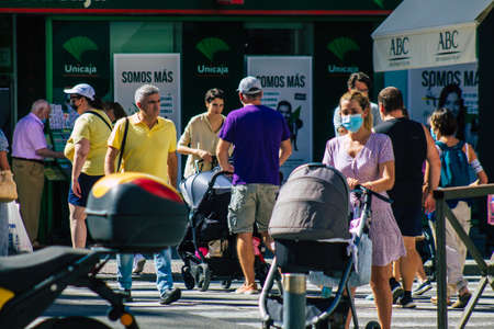 Seville Spain September 18, 2021 Pedestrians walking in the street during the coronavirus outbreak hitting Spain, wearing a mask is not mandatory but most of people wear itのeditorial素材