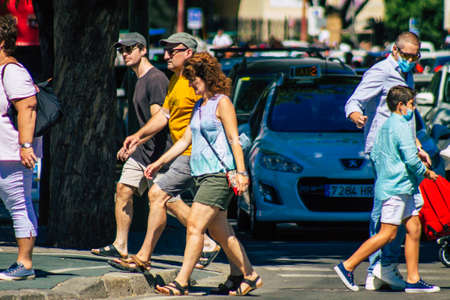 Seville Spain September 18, 2021 Pedestrians walking in the street during the coronavirus outbreak hitting Spain, wearing a mask is not mandatory but most of people wear itのeditorial素材