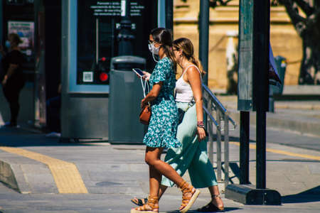 Seville Spain September 18, 2021 Pedestrians walking in the street during the coronavirus outbreak hitting Spain, wearing a mask is not mandatory but most of people wear itのeditorial素材