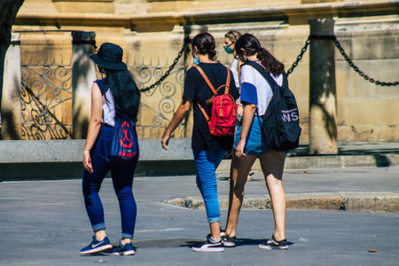 Seville Spain September 18, 2021 Pedestrians walking in the street during the coronavirus outbreak hitting Spain, wearing a mask is not mandatory but most of people wear itのeditorial素材