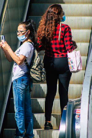 Seville Spain September 18, 2021 Pedestrians using an escalator during the coronavirus outbreak hitting Spain, wearing a mask is not mandatory but most of people wear itのeditorial素材