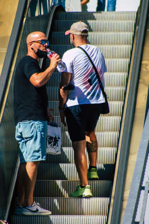 Seville Spain September 18, 2021 Pedestrians using an escalator during the coronavirus outbreak hitting Spain, wearing a mask is not mandatory but most of people wear itのeditorial素材