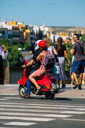 Seville Spain September 18, 2021 People rolling with a motorcycle in the streets of Seville, an emblematic city and the capital of the region of Andalusia, in the south of Spainのeditorial素材
