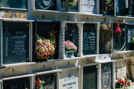 Seville Spain September 21, 2021 Typical graves in a Christian cemetery of the municipality of Carmona in Andalusia in southern Spain, the graves are made in the depth of a wall and richly decoratedのeditorial素材