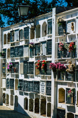 Seville Spain September 21, 2021 Typical graves in a Christian cemetery of the municipality of Carmona in Andalusia in southern Spain, the graves are made in the depth of a wall and richly decoratedのeditorial素材