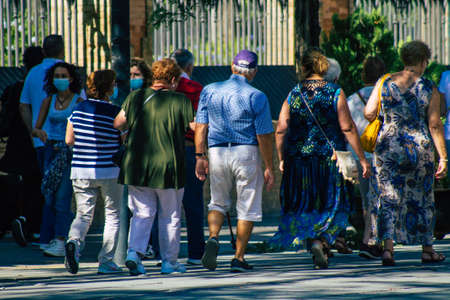 Seville Spain September 22, 2021 Pedestrians walking in the street during the coronavirus outbreak hitting Spain, wearing a mask is not mandatory but most people wear itのeditorial素材