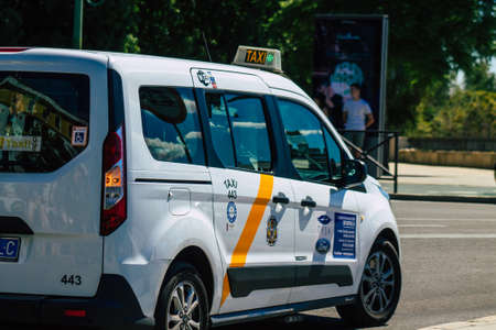 Seville Spain September 18, 2021 Taxi driving through the streets of Seville during the coronavirus outbreak hitting Spain, wearing a mask is mandatoryのeditorial素材