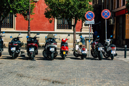 Seville Spain September 18, 2021 Motorcycles parked in the streets of Seville, an emblematic city and the capital of the region of Andalusia, in the south of Spainのeditorial素材