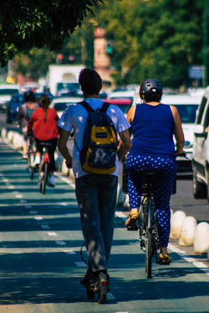 Seville Spain September 28, 2021 People rolling with an electric scooter in the streets of Seville, operating with a small utility internal combustion engines and a deck in the centerの写真素材