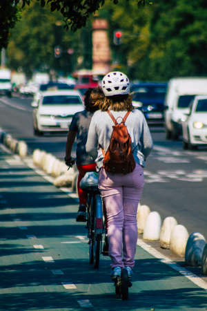 Seville Spain September 28, 2021 People rolling with an electric scooter in the streets of Seville, operating with a small utility internal combustion engines and a deck in the centerの写真素材