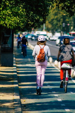 Seville Spain September 28, 2021 People rolling with an electric scooter in the streets of Seville,...
