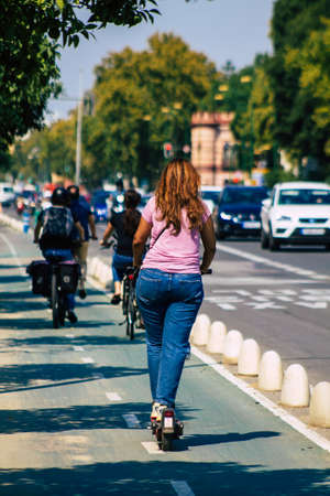 Seville Spain September 28, 2021 People rolling with an electric scooter in the streets of Seville, operating with a small utility internal combustion engines and a deck in the centerの写真素材